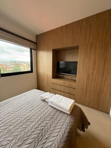 a bedroom with a bed with two towels on it at Amazing and in the chic area in Tarija