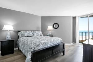 a bedroom with a bed and a view of the ocean at St Regis 1505 in Chadwick Acres