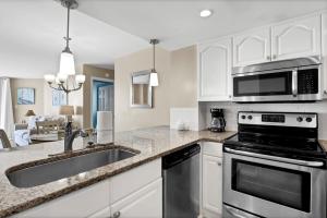 a kitchen with a sink and a stove at St Regis 1505 in Chadwick Acres +41 photos