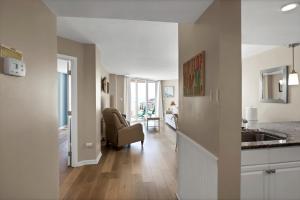 a kitchen with a sink and a living room at St Regis 1505 in Chadwick Acres