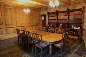 a dining room with a wooden table and chairs at Mingary Castle - Restaurant with Rooms in Kilchoan