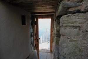 a door in a room with a view of the ocean at Mingary Castle - Restaurant with Rooms in Kilchoan