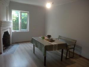 a room with a table and a chair and a window at Guest house with two rooms in Zugdidi
