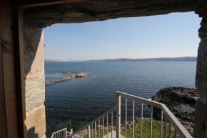 a view of the ocean from a window at Mingary Castle - Restaurant with Rooms in Kilchoan