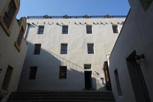 a large white building with stairs in an alley at Mingary Castle - Restaurant with Rooms in Kilchoan