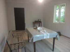 a room with a table and a wooden floor at Guest house with two rooms in Zugdidi +1 photo