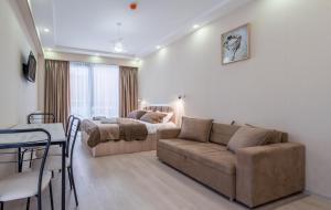 a living room with a couch and a bed at GVC New Gudauri Twins 413 Mountain View in Gudauri