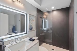 a bathroom with a sink and a shower and a toilet at Ammos Luxury Living- Crete Suite in Ventnor City