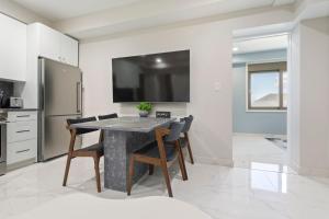 a kitchen with a table with chairs and a refrigerator at Ammos Luxury Living- Crete Suite in Ventnor City