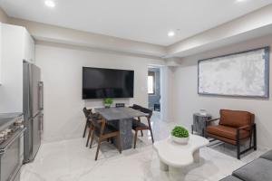 a living room with a table and chairs and a tv at Ammos Luxury Living- Crete Suite in Ventnor City +14 photos