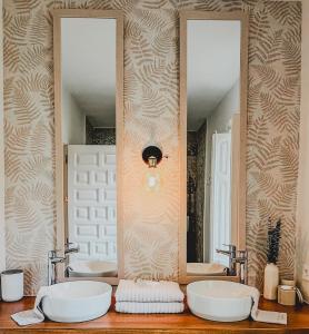 a bathroom with two sinks and two mirrors at Seraphina Bookings Mojacar in Mojácar
