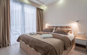 a bedroom with a large bed and a large window at GVC New Gudauri Twins 413 Mountain View in Gudauri +51 photos