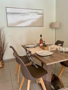 a dining room with a wooden table and chairs at Louloudi Apartment in Tsilivi +28 photos