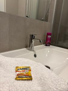 a bathroom sink with a tube of toothpaste on it at Macabu Apartment Sophie in Zwickau