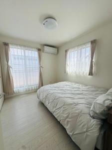 Postel nebo postele na pokoji v ubytování 福の荘 空港2号棟 + 9 fotografií