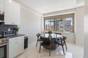a kitchen with a table and chairs and a window at Ammos Luxury Living- Zakinthos Suite in Ventnor City