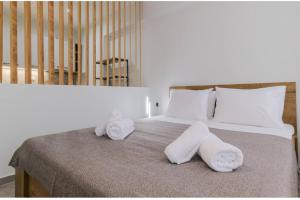 a bed with two towels on top of it at Ladadika Vibes Studio 1 in Thessaloniki