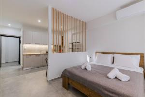 a bedroom with a large bed and a kitchen at Ladadika Vibes Studio 1 in Thessaloniki