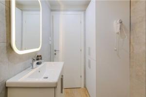 a bathroom with a sink and a mirror and a shower at Ladadika Vibes Studio 1 in Thessaloniki