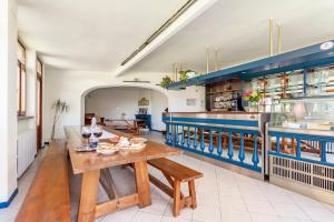 a kitchen with a wooden table and blue cabinets at Da Carlin in Armeno