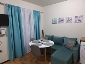 a living room with a couch and a table at Studio Anelia in Sveti Vlas