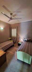 Un dormitorio con dos camas y un ventilador de techo. en Sal service green moradias residence with pool, en Santa Maria 50 fotos más