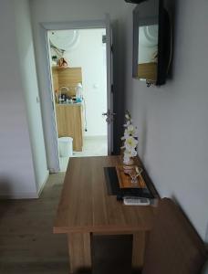 a living room with a wooden table and a television at Soba Ðorović 3 in Postenje