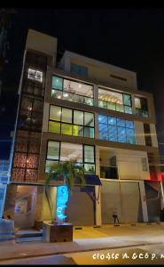 a building with a palm tree in front of it at Hotel Santa Clara Boutique in Montería