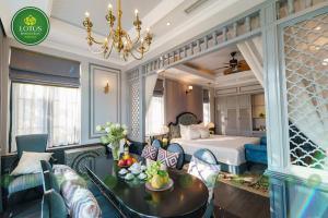 a hotel room with a bed and a table and chairs at Lotus Hotel Vuon Vua Phu Tho in Phú Thọ +139 photos