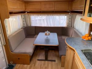 a small table in the back of a tiny caravan at Przyczepa kempingowa Happy Place Hel - Camping Kormoran in Hel