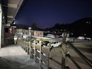 a parking lot at night with cars parked in a parking lot at Hotel Grand View in Barkot