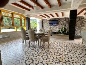 a dining room with a table and chairs at Hotel Boutique Sagrado Corazon in Abejorral