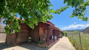 a small wooden house with a fence at Les Valletes in Arnés