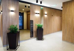 a hallway with two potted plants in a building at OnTop Apartments in Braşov