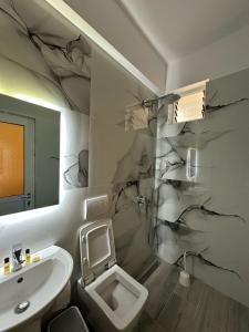 a bathroom with a toilet and a sink at Hotel Marku in Ksamil +37 photos