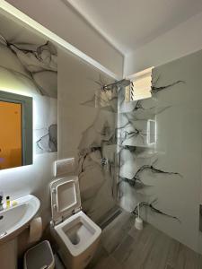 a bathroom with a toilet and a sink at Hotel Marku in Ksamil