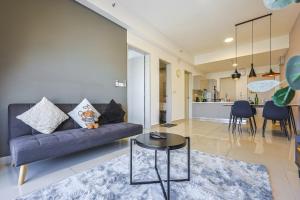 a living room with a couch and a table at Trion Kuala Lumpur by Vivid Stay in Kuala Lumpur