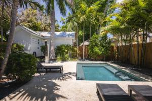 a backyard with a swimming pool and a house at Coconut Palm in Key West
