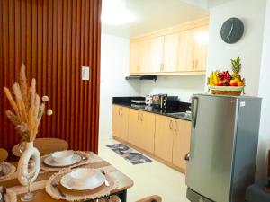 a kitchen with a stainless steel refrigerator and a table at Casa Eden in Tagaytay