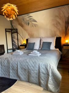 a bedroom with a bed with two towels on it at Waldhof Hochsauerland in Medebach