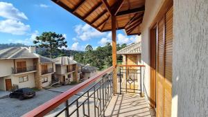 a balcony of a house with a view of a street at Chalé Coração de Monte Verde in Monte Verde