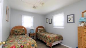a bedroom with a bed and a chair at 12 Mechanic St in West Cape May
