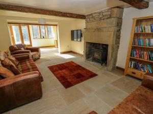 a living room with a couch and a fireplace at Pule Hill Farm in Huddersfield