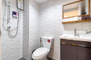a bathroom with a toilet and a sink at Bangkok Watergate Townhouse 曼谷中心水門家 in Bangkok +63 photos