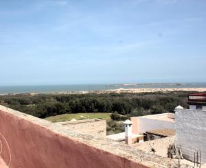 a view of the ocean from the roof of a building at Dar Ba à 15 min à pied de la mer in Essaouira