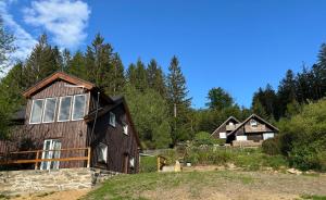 a home in the woods with trees at Chata Jezevec - samostatný apartmán in Nýrsko