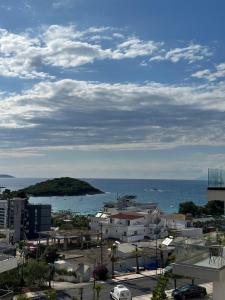 a view of a city and the ocean with buildings at Hotel Marku in Ksamil