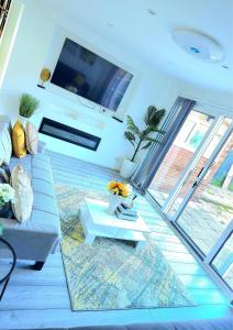 a living room with a couch and a tv at Large House, Home for Contractors- Park Free in Chatham +40 photos