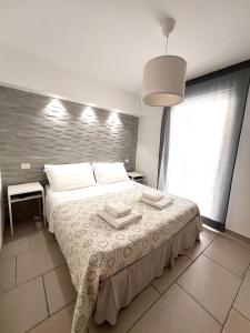 Postel nebo postele na pokoji v ubytování Salentoguests villetta sulla spiaggia