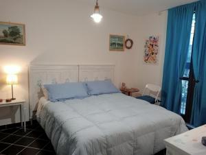 a bedroom with a large bed with blue pillows at Alloggio turistico MARBO in Civitavecchia